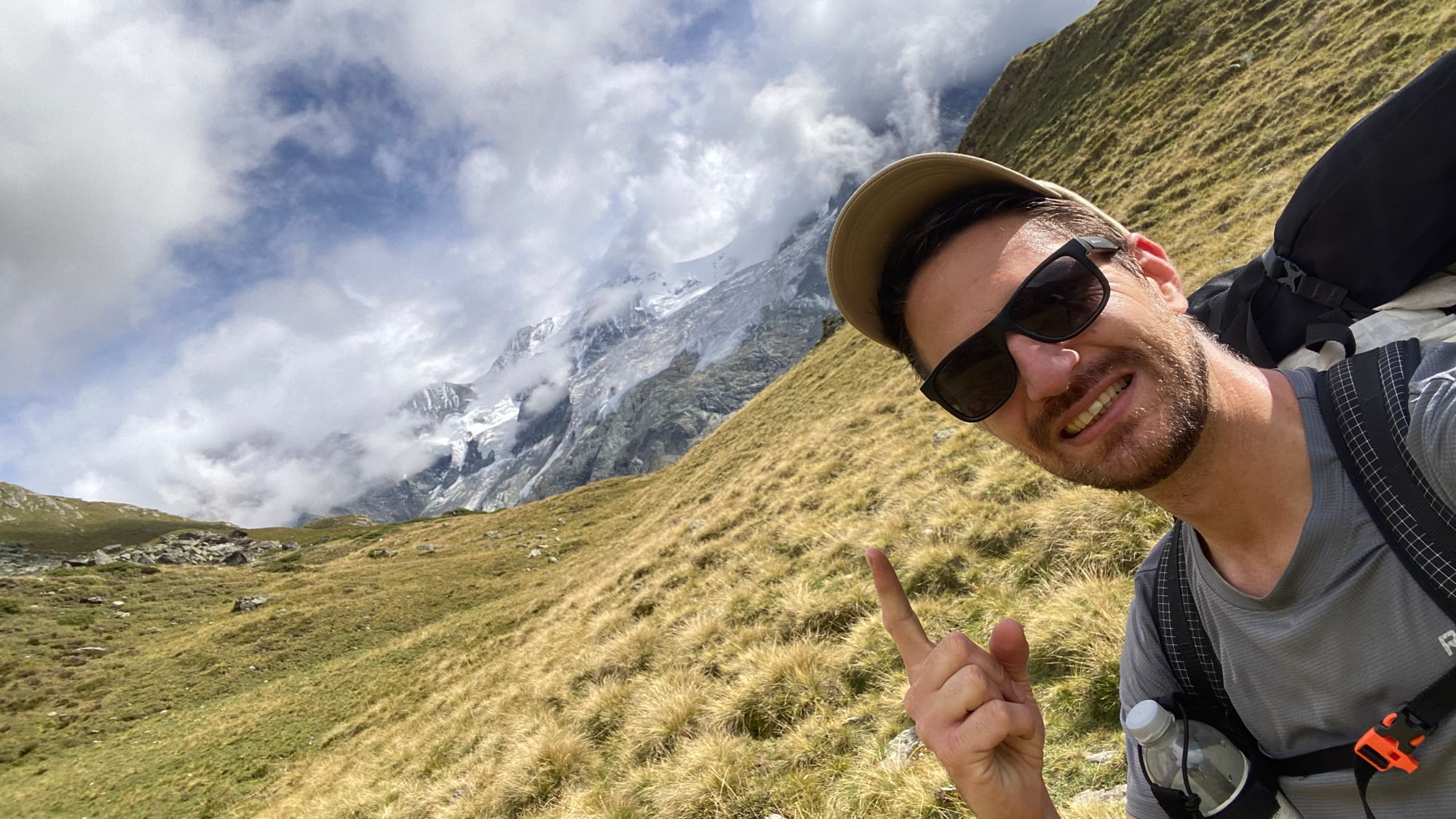 Marc on a trail in Val d'Anniviers, the Moming Glacier behind in the clouds.